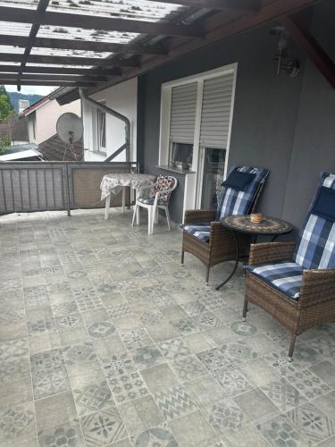 a patio with chairs and a table on a porch at Ferienwohnung Liliane in Rielasingen-Worblingen