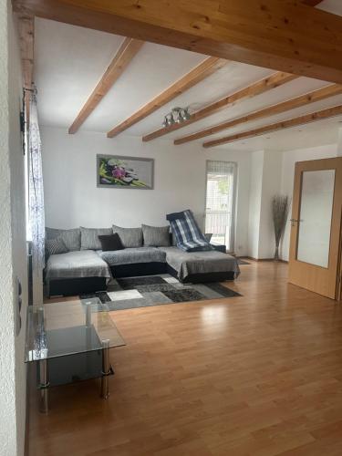 a living room with a couch and a table at Ferienwohnung Liliane in Rielasingen-Worblingen