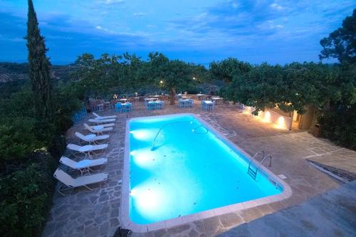 an overhead view of a swimming pool with tables and chairs at Petropoulakis Tower in Gythio