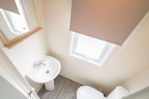 a bathroom with a sink and a toilet at Marine Holiday Park in Rhyl