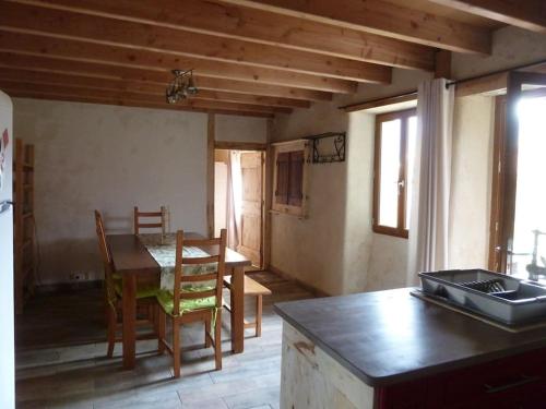 a kitchen with a table and a dining room at Maison en éco construction in Piégros-la-Clastre