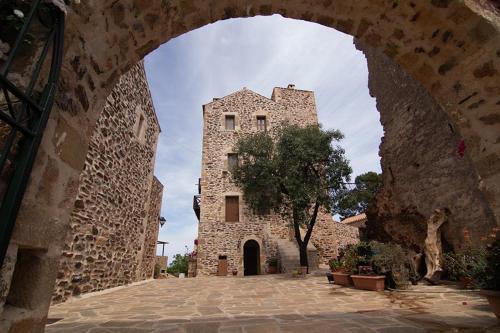 a large stone building with an archway at Petropoulakis Tower in Gythio