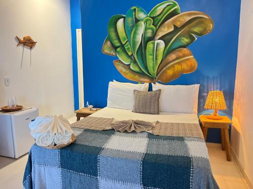 a bedroom with a bed with a large plant on it at Pousada Nascente do Sol in Ilha de Boipeba