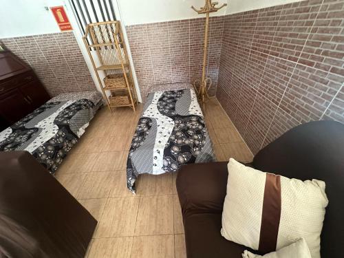 a living room with two beds and a couch at Casas Rurales La Picotilla y la Guija in Martiherrero