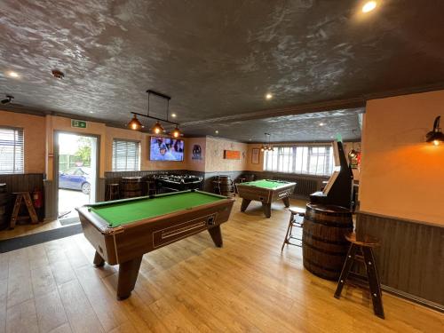 a room with a pool table and a bar at The Barrington Hotel in New Barnet