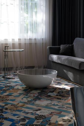 a living room with a large bowl on the floor at Amsterdam Plaza Hotel & SPA in Palanga