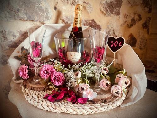 a basket with a bottle of wine and flowers at La Quinta Luxury Palace in Arnuero
