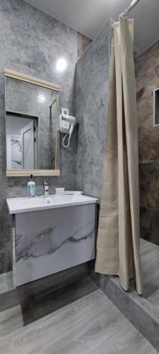 a bathroom with a sink and a mirror at EVFRAT-Q in Taraz