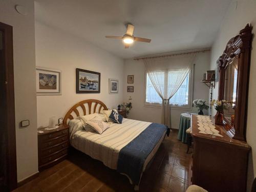 a bedroom with a bed and a ceiling fan at Calella Playa in Calella
