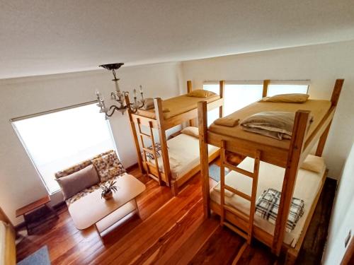 a room with two bunk beds and a couch at Hostal Mochiliers Bed and Breakfast in Cuenca