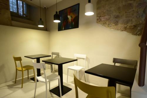 a dining room with two tables and chairs at Little Italy Hostel Ex Chiesa S Donato in Perugia