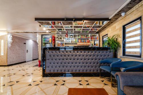 a bar at a restaurant with blue chairs at РИМ Grand Hotel in Almaty