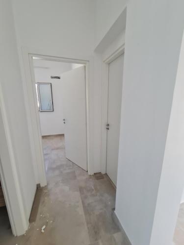 an empty room with a door and a hallway at Elsa Holiday Home in Fontane Bianche