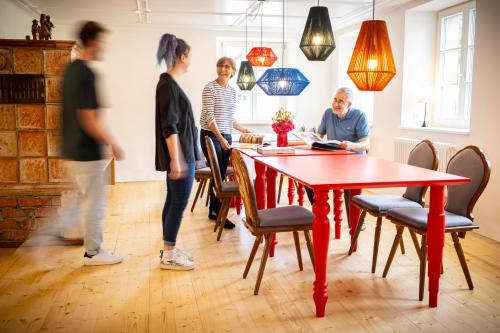 a group of people standing around a table in a room at schlossmühle - lean luxury boutique hotel in Glottertal