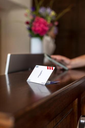 a desk with a pen and a piece of paper on it at schlossmühle - lean luxury boutique hotel in Glottertal