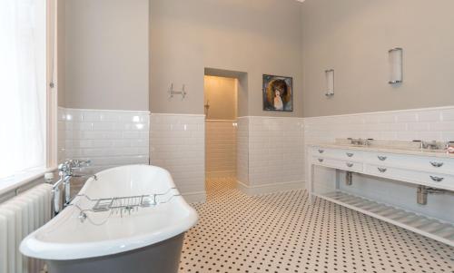 a white bathroom with a sink and a toilet at Hawkstone Hall Hotel & Gardens in Shrewsbury
