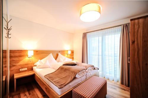 Postel nebo postele na pokoji v ubytování Hotel Dorfstadl
