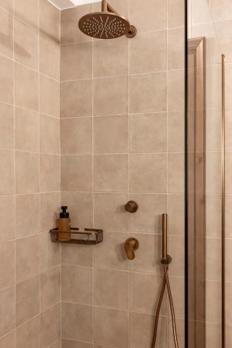 a bathroom with a shower with a glass door at Mount Minis - Casa Bruno in Syvota