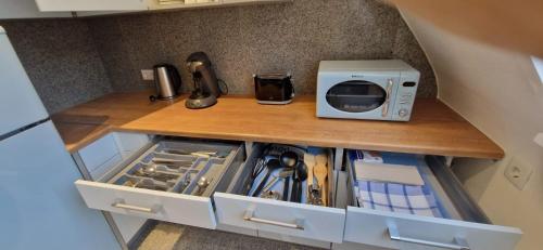 a kitchen counter with a microwave on top of it at Renatas Ferienwohnung ISABEL in Sasbachwalden