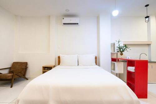 a bedroom with a large white bed and a red cabinet at Gemini Saigon CENTER - New & Quiet near Bui Vien Walking Street in Ho Chi Minh City