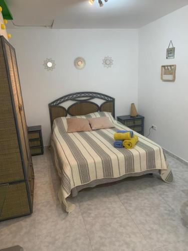 a bedroom with a bed with a yellow stuffed animal on it at Estudio en la Muralla roja in Calpe