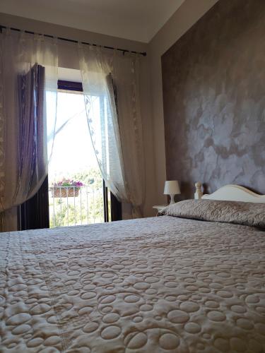 a bedroom with a large bed and a window at Agriturismo Donna Bianca in Mormanno