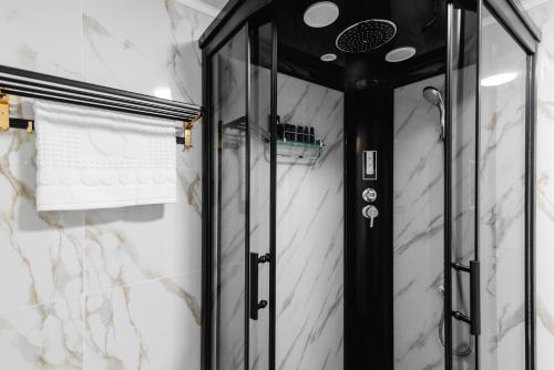 a shower with black and white marble at РИМ Grand Hotel in Almaty