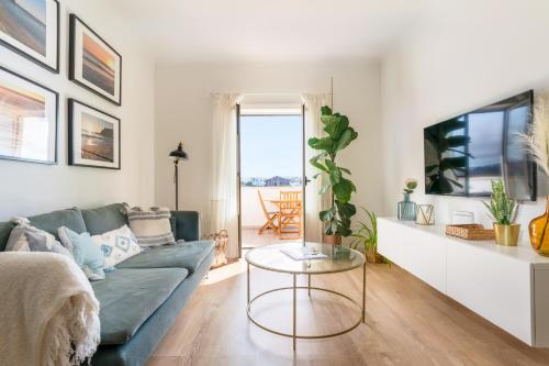 a living room with a couch and a table at Clifftop Nest Arrifana in Aljezur