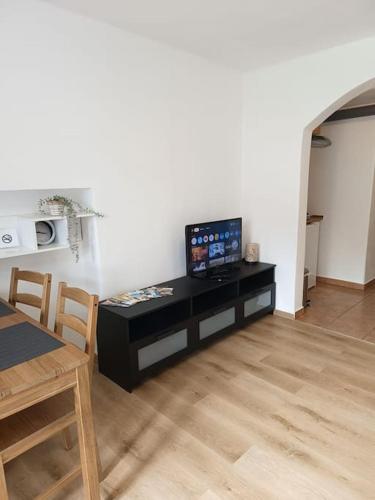 a living room with a table with a television on it at Ubytování pod Ostašem in Police nad Metují