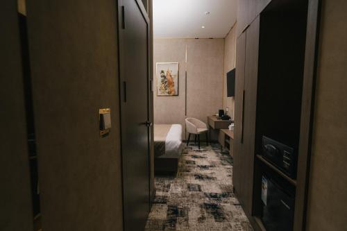 a corridor of a hotel room with a bedroom at Grand Castle Hotel in Urganch