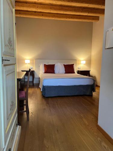 a bedroom with a bed and a desk and a bed at Villa Maria Luigia in San Biagio di Callalta