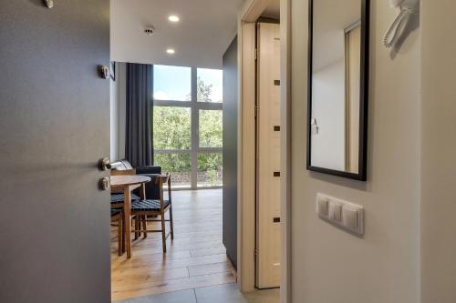 a door leading to a dining room with a table at Uptown Lofts in Vilnius