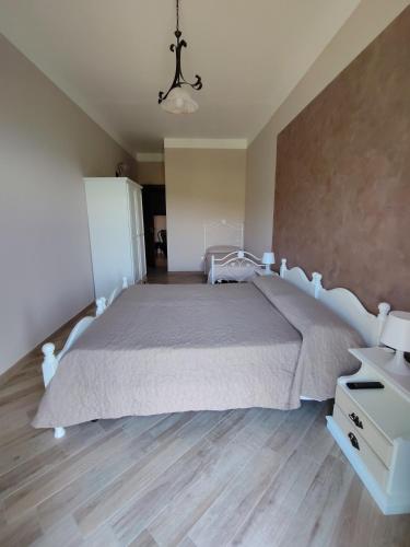 a bedroom with a large bed and a dresser in it at Agriturismo Donna Bianca in Mormanno