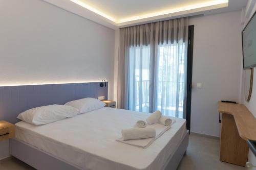 a bedroom with a bed with two towels on it at Oktolia suites in Alexandroupoli