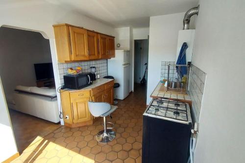 Il comprend une petite cuisine équipée d'une cuisinière et d'un évier. dans l'établissement Chambre privée dans un appartement en collocation, à Oullins