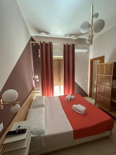 a bedroom with a bed with two towels on it at B&B Elegance in Villa San Giovanni