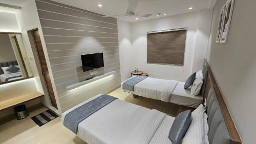 Hotel veesons executiveにあるテレビまたはエンターテインメントセンター
