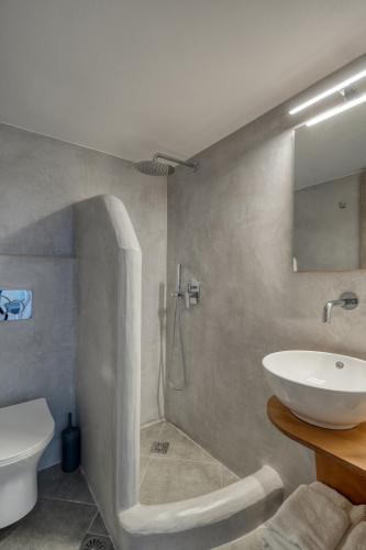a bathroom with a sink and a toilet and a shower at Sunrise in Livadakia