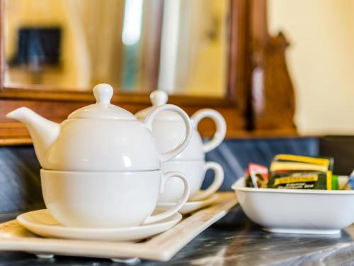 a white tea set on a table with a bowl at Sangaggio House B&B in Florence