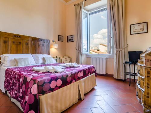 a bedroom with a large bed with a large window at Sangaggio House B&B in Florence
