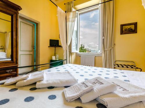 a bedroom with a bed with towels on it at Sangaggio House B&B in Florence
