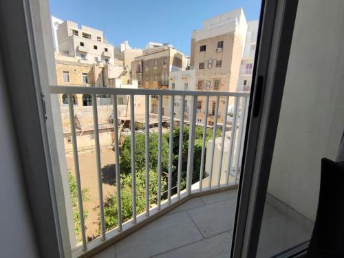 a view from the window of a balcony at Cosy Seaside APT, 200m from the Seafront in Il-Gżira