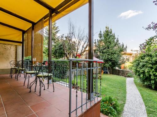 a patio with tables and chairs and a fence at Sangaggio House B&B in Florence