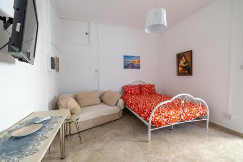 a living room with a couch and a table at Studio in the heart of the city in Paphos