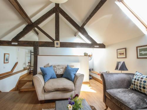 a living room with two chairs and a couch at Foxholes Barn in Kidderminster
