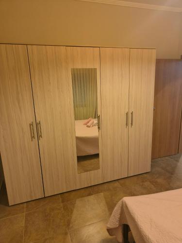 a large wooden cabinet with a mirror in a bedroom at marina in Dhidhimótikhon