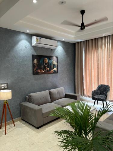 a living room with a couch and a fan at Bhullars villa in Sohāna