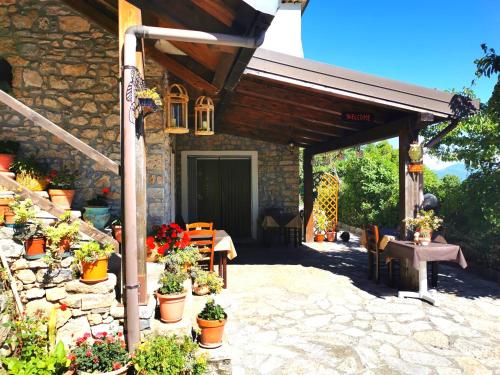 a stone house with a patio with potted plants at Agriturismo Donna Bianca in Mormanno