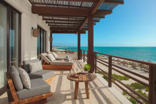a balcony with a view of the ocean at Secrets Playa Blanca Costa Mujeres - All Inclusive Adults Only in Cancún