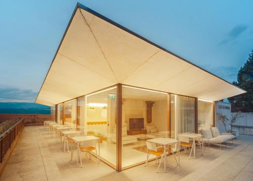 a pavilion with tables and chairs on a roof at Casa das Ameias in Vouzela